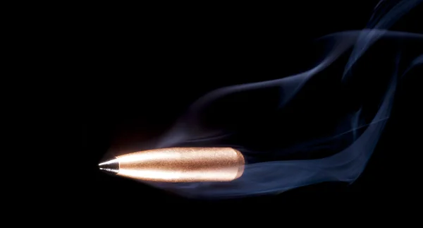 Lone bullet with smoke behind — Stock fotografie