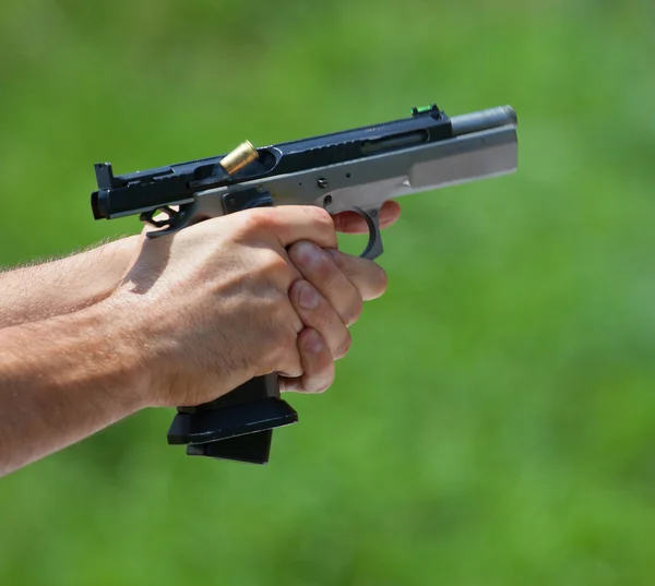 Brass ejecting from a pistol — Stock Photo, Image