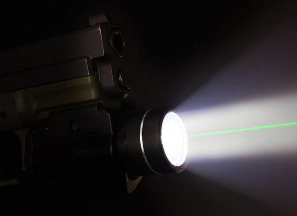 Handgun with a flashlight and laser