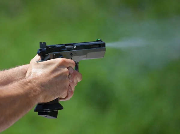 Bullet leaving a handgun — Stock Photo, Image