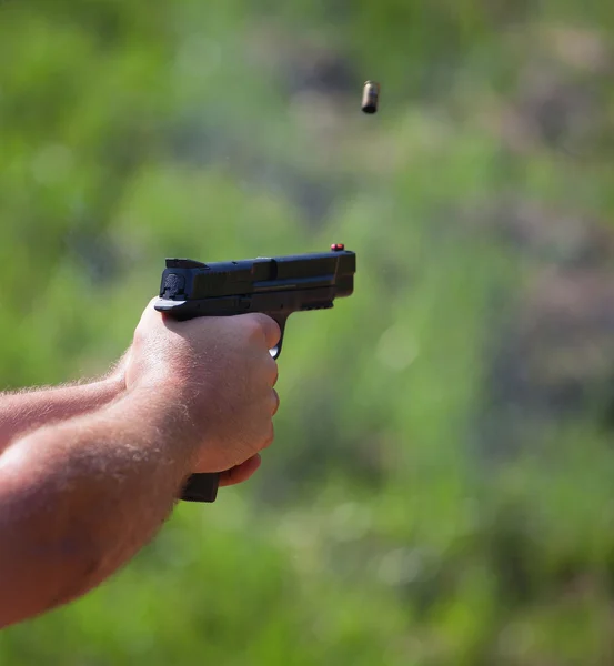Flying Brass from a handgun Stock Picture
