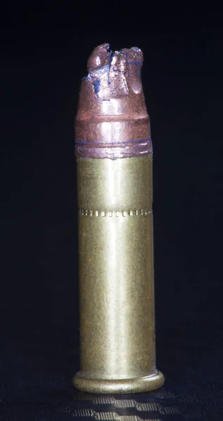 Chewed bullet on black — Stock Photo, Image
