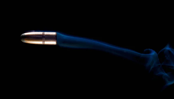 Blue smoke behind a bullet — Stock Photo, Image