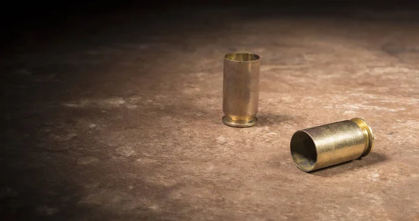 45 caliber handgun casings sitting on the floor