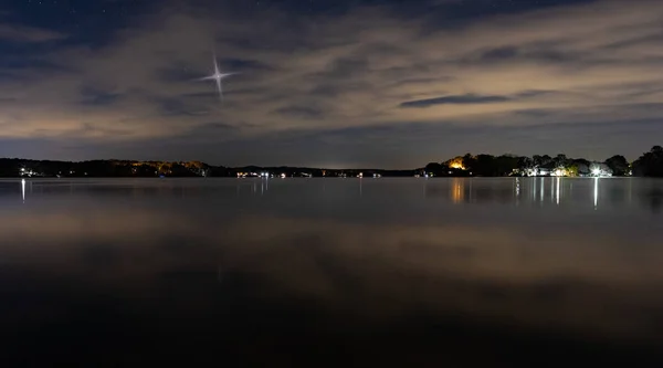 Estrella de Navidad levantándose sobre las casas junto al lago — Foto de Stock