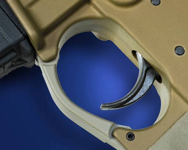 AR-15 trigger and shadow on blue — Stock Photo, Image