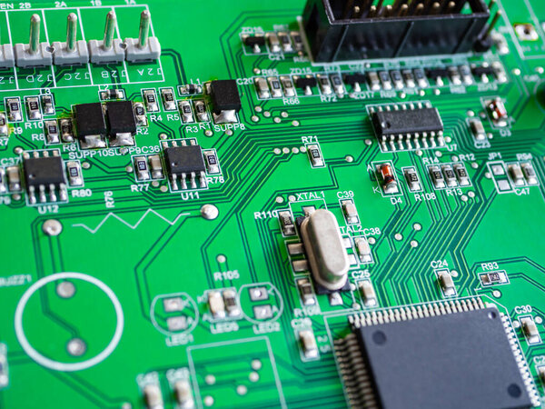 Close-up of printed electronic circuit board with processor and many integrated electrical components. Nanotechnology hardware system. Modern digital science concept. CPU welding or assembled on PCB.