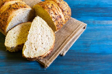 Mavi masadaki zanaatkar tohumu ekmeği, tapas veya sandviç için idealdir.