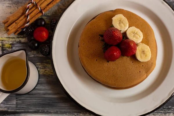 hot cakes or pancakes with red berries, strawberries, blackberries for breakfast, top view, horizontal