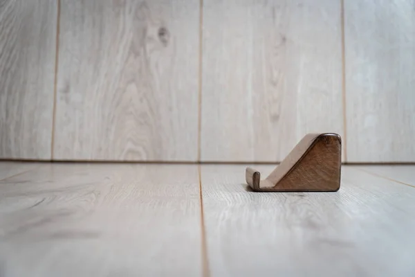 Wooden stand for phone on a wooden background