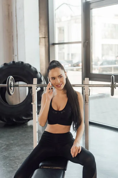 Beautiful Sportswoman Sitting Sport Equipment Smiling Talking Smartphone Barbell Gym — Stock Photo, Image