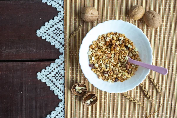 Healthy lifestyle. Healthy and nutritious muesli in a plate. For Breakfast-natural muesli with nuts. The view from the top. Space for your text — Stock Photo, Image