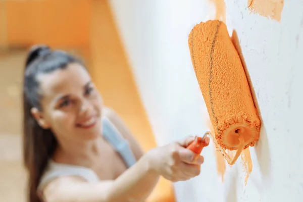 Repair Apartment Happy Young Woman Paints Wall Orange Color — Stock Photo, Image