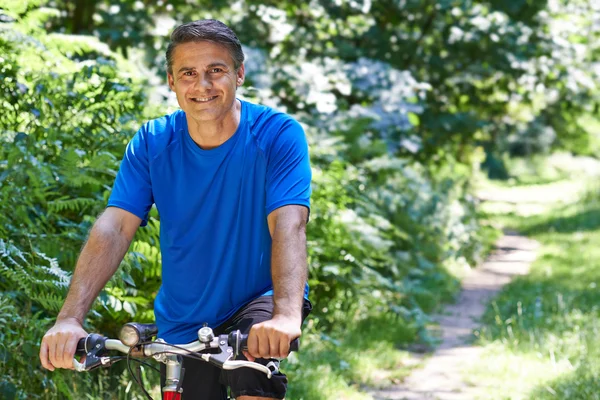 Mature Man Cycling Along Path In Countryside — Stock Photo, Image