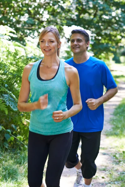 Mature Couple Running In Countryside — Stock Photo, Image