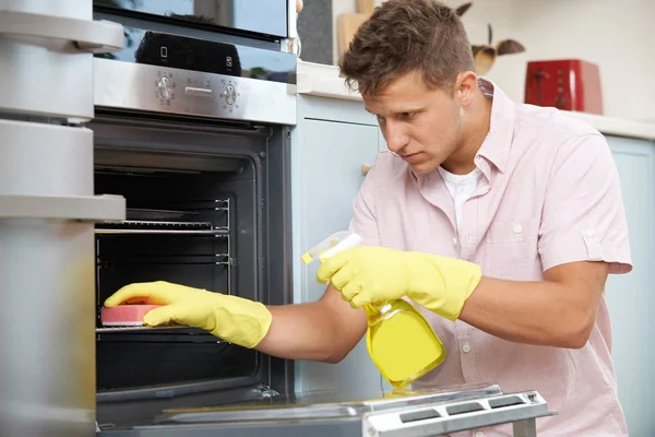 Fed Up Woman Cleaning Oven At Home — Stock Photo, Image
