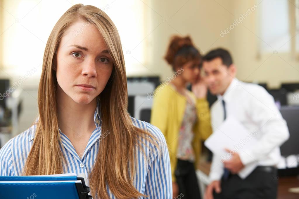 Businesswoman Being Gossiped About By Colleagues In Office