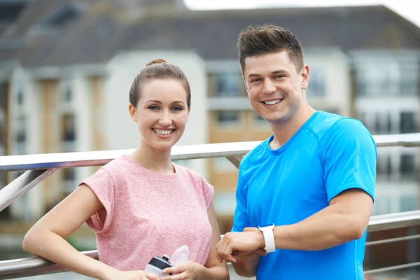 Couple Looking At Activity Tracker Whilst Exercising In City — Stock Photo, Image