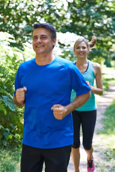 Mature Couple Running In Countryside — Stock Photo, Image