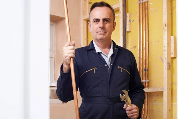 Portrait Of Male Plumber Working In House