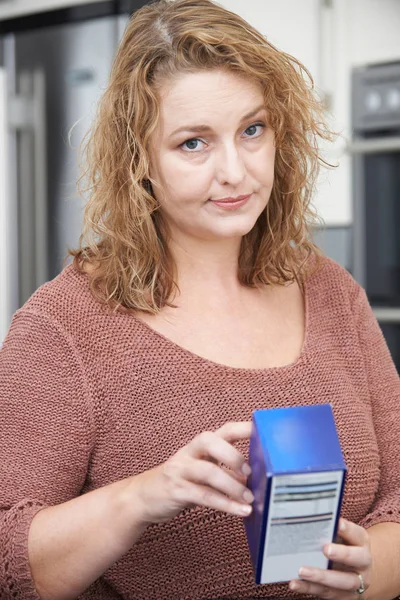 Concerned Plus Size Female Reading Nutritional Information On Pa — Stock Photo, Image