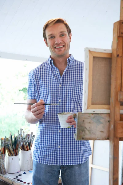 Portrait Of Male Artist Painting In Studio