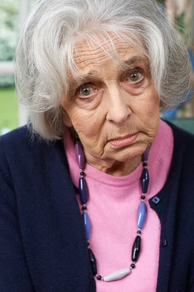 Head And Shoulders Portrait Of Unhappy Senior Woman At Home — Stock Photo, Image