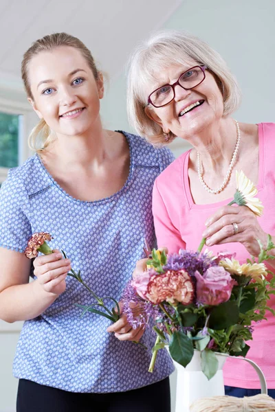 Mujer mayor con maestro en clase de arreglos florales — Foto de Stock