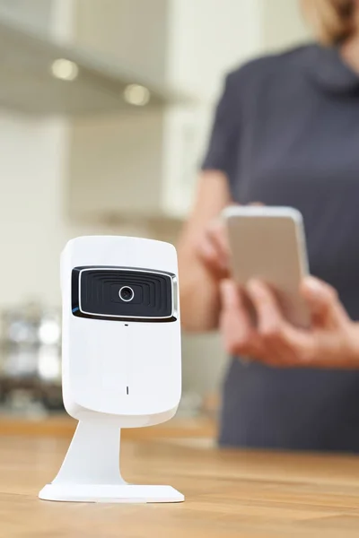 Woman Controlling Smart Security Camera Using App On Mobile Phon — Stock Photo, Image