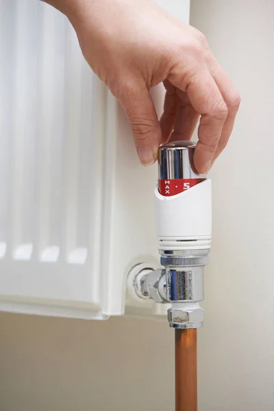 Close Hand Adjusting Heating Thermostat — Stock Photo, Image