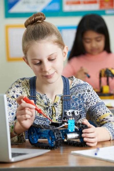 Female Pupils In Science Lesson Studying Robotics