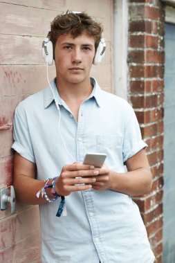 Kulaklık takmış ve kentsel s müzik genç çocuk