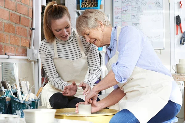 Senior vrouw met leraar In aardewerk klasse — Stockfoto