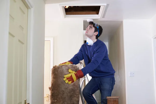Man Climbing Into Loft To  Insulate House Roof — Stock Photo, Image