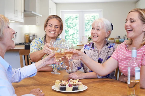 Group Of Different Aged Female Friends Meeting At Home