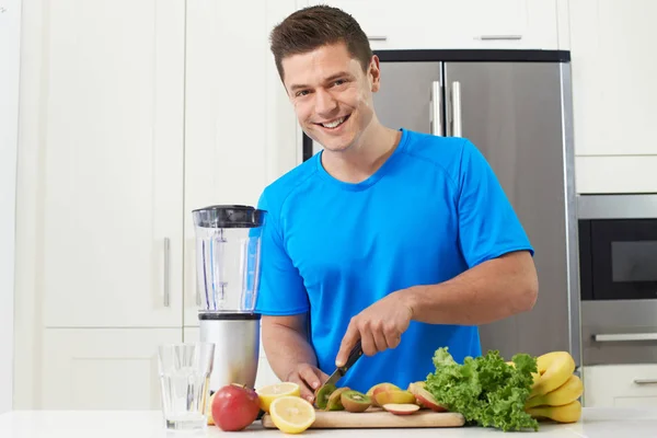 Male Athlete Making Juice Or Smoothie In Kitchen — Stock Photo, Image