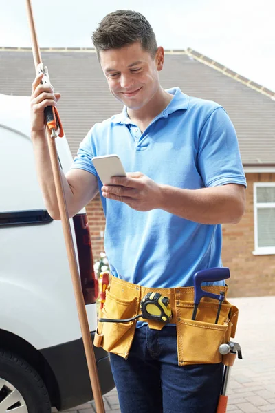 Plumber With Van Texting On Mobile Phone Outside House — Stock Photo, Image