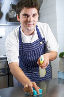 Worker In Restaurant Kitchen Cleaning Down After Service clipart