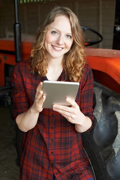 Female Agricultural Worker On Farm Using Digital Tablet