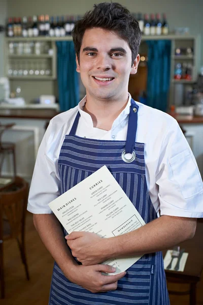 Portrait Of Chef Standing In Restaurant Holding Menu — Stock Photo, Image