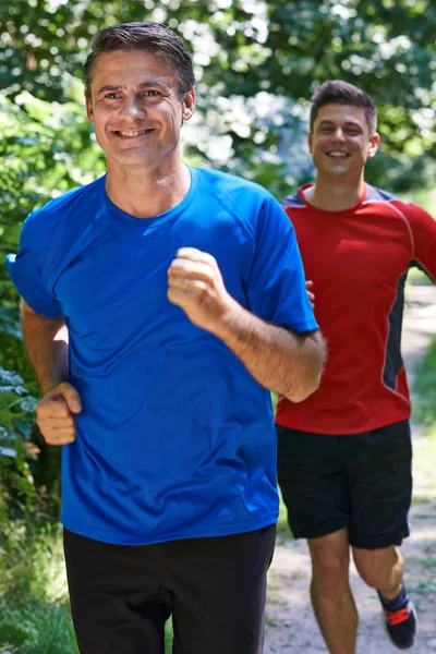 Two Men Running In Countryside Together — Stock Photo, Image