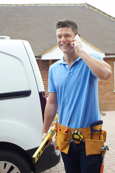 Construtor com Van falando no telefone móvel fora da casa — Fotografia de Stock