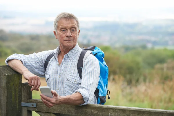 Senior Man Checking Location With Mobile Phone On Hike — Stock Photo, Image