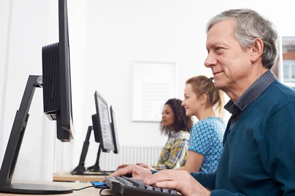 Mature Man Attending Computer Class Stock Photo