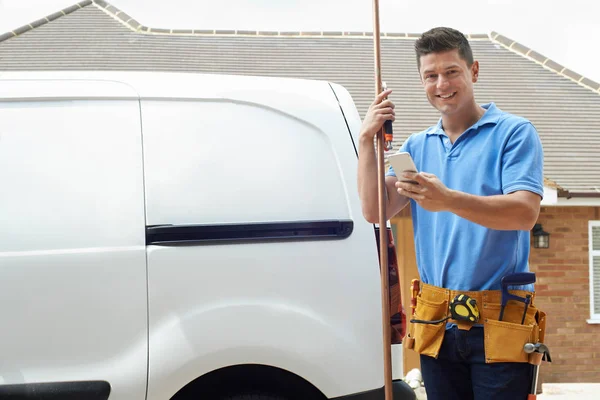 Portrait Of Plumber With Van Texting On Mobile Phone Outside Hou — Stock Photo, Image