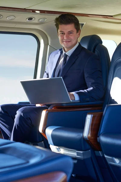Portrait Of Businessman Working On Laptop In Helicopter Cabin Du — Stock Photo, Image