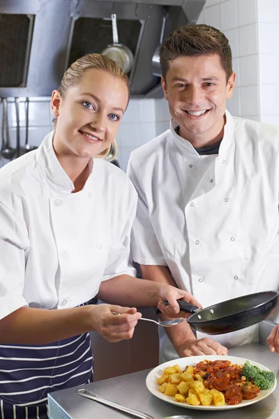 Portrait Of Chef Instructing Female Trainee In Restaurant Kitche — Stock Photo, Image