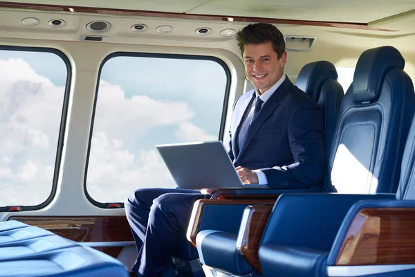 Portrait Of Businessman Working On Laptop In Helicopter Cabin Du — Stock Photo, Image