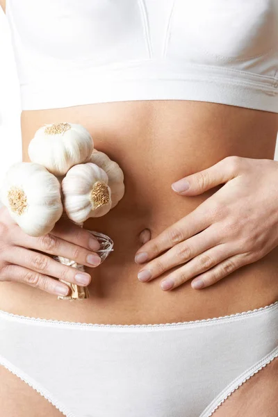 Close Up Of Woman In Underwear Holding Bunch Of Garlic And Touch — Stock Photo, Image