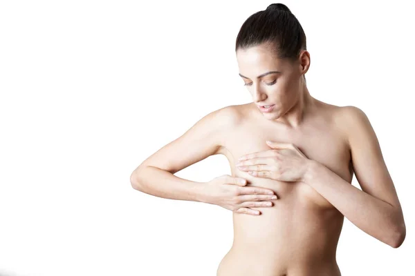 Studio Shot Of Naked Woman Examining Breast — стоковое фото